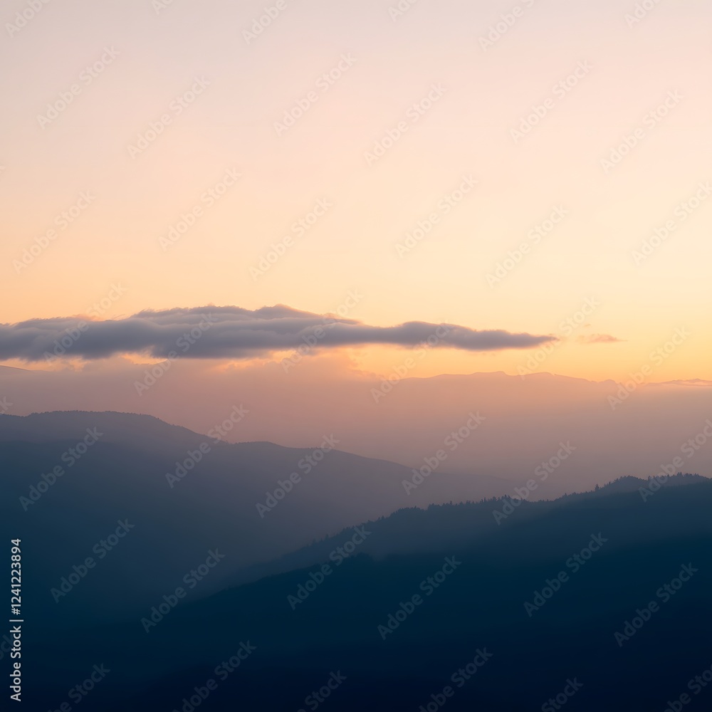 Fototapeta premium A serene and majestic sunrise unfolds over a range of misty mountains