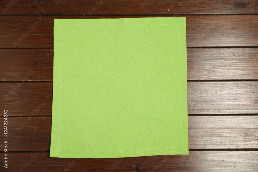 Light green napkin on wooden table, top view Light green napkin on wooden table, top view