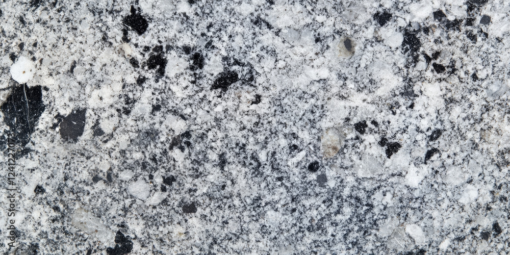 High-detail granite stone background with speckled minerals in shades of gray, white, and black. High-detail granite stone background with speckled minerals in shades of gray, white, and black.