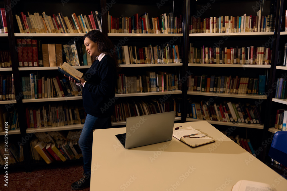 Woman reading a book in a library setting with open notebooks Woman reading a book in a library setting with open notebooks