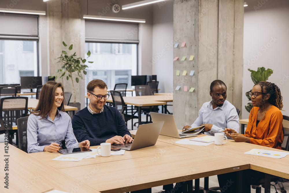 Professional team collaborating, using digital devices, brainstorming project details in contemporary workplace with natural lighting Professional team collaborating, using digital devices, brainstorming project details in contemporary workplace with natural lighting