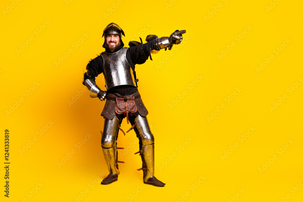 Cheerful man in medieval knight armor posing on vibrant yellow background Cheerful man in medieval knight armor posing on vibrant yellow background