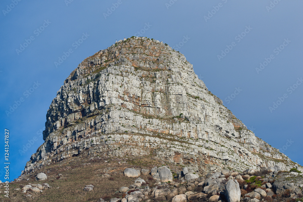 Fototapeta premium Rock, blue sky and mountain with hill or slope for natural scenery in outdoor wilderness. Empty, stones and earth with landscape, landmark or view of cliff in nature for scenic adventure or tourism