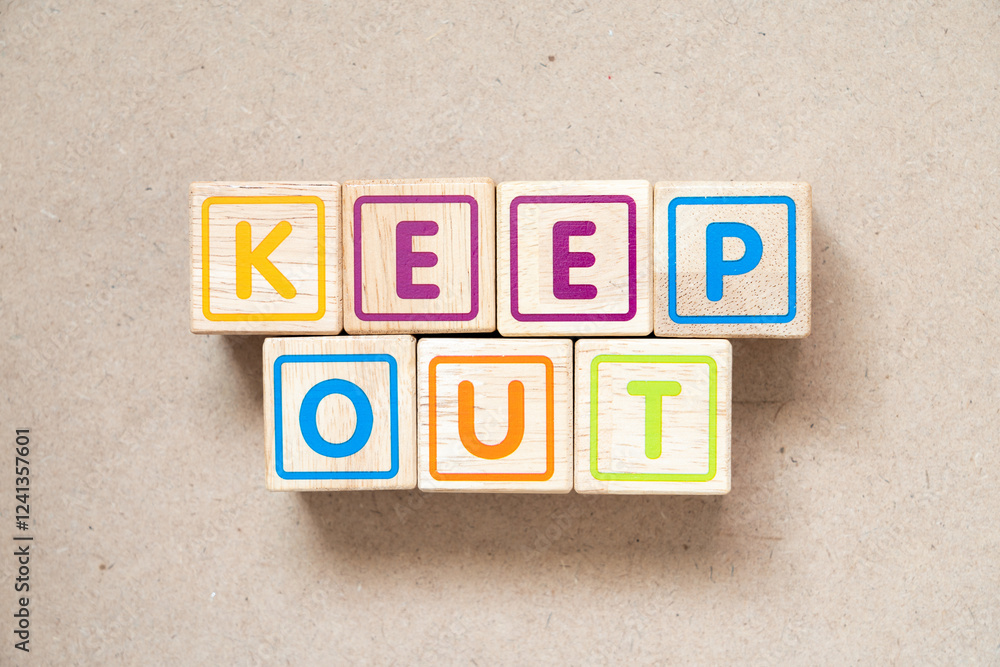 Alphabet letter block in word keep out on wood background Alphabet letter block in word keep out on wood background
