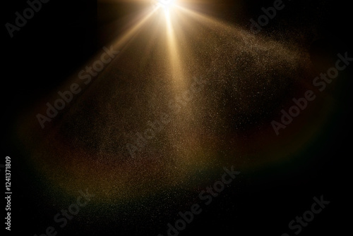 Dust particles shimmer in a radiant sunbeam against a dark background, creating a mystical god rays atmosphere