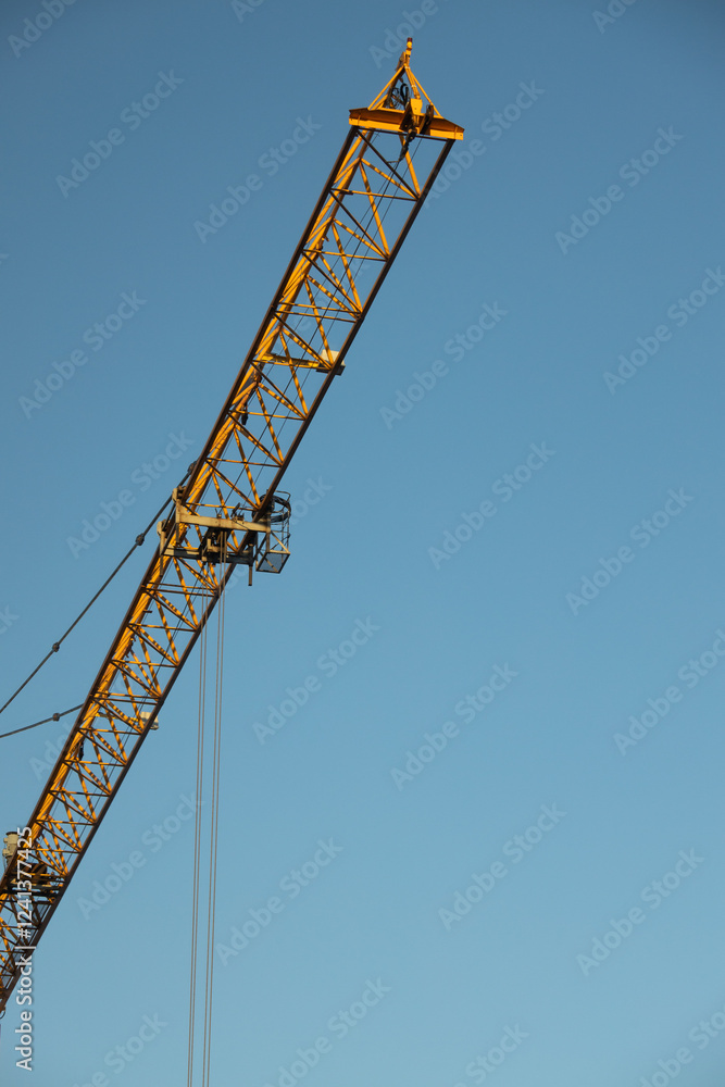 Construction Yellow crane against blue sky Construction Yellow crane against blue sky