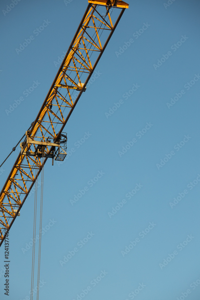 Construction Yellow crane against blue sky Construction Yellow crane against blue sky