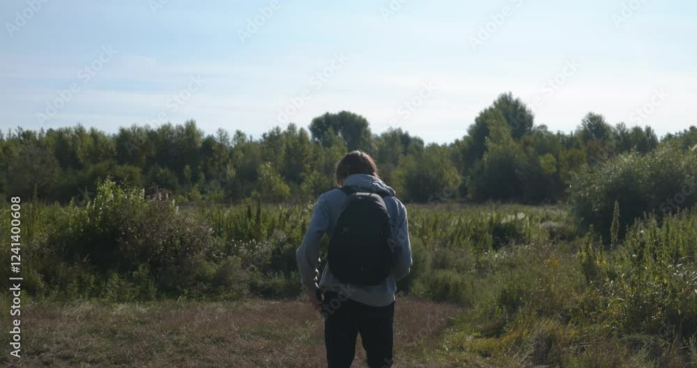 Caucasian Man Walks With Smartphone Near River. Hiking on Nature. Slow motion 60fps 4K 10-bit Caucasian Man Walks With Smartphone Near River. Hiking on Nature. Slow motion 60fps 4K 10-bit