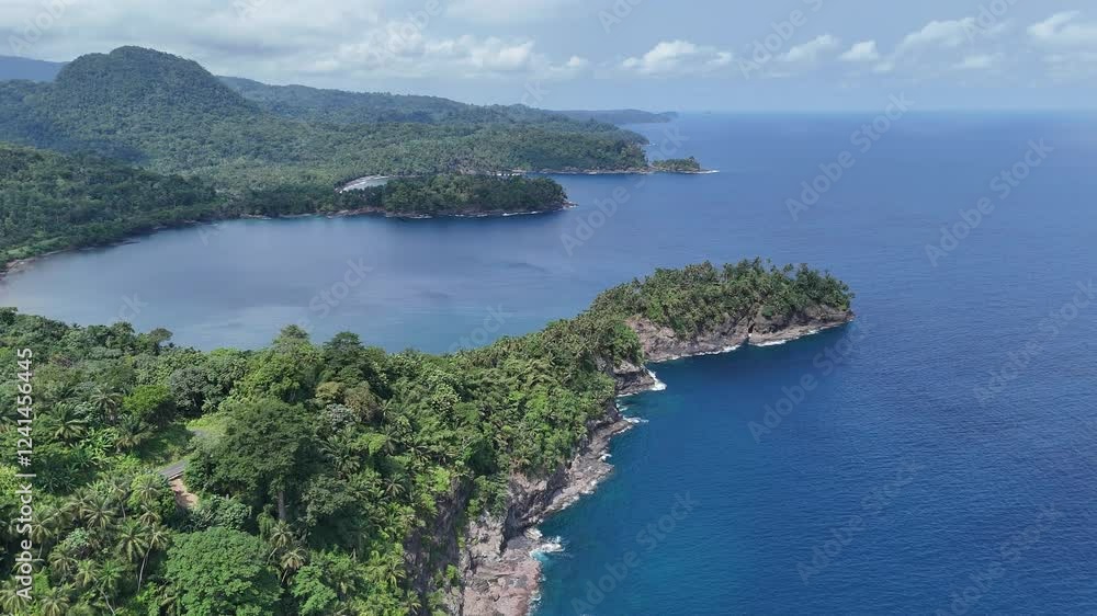 Sao Tome and Principe - Aerial View Near Micondo. Stunning Tropical Coastline With Lush Green Hills and Deep Blue Ocean. Sao Tome and Principe - Aerial View Near Micondo. Stunning Tropical Coastline With Lush Green Hills and Deep Blue Ocean.