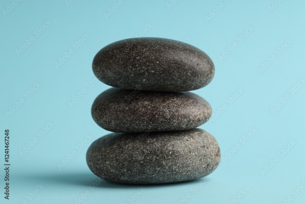 Stack of rocks on light blue background. Harmony and life balance Stack of rocks on light blue background. Harmony and life balance