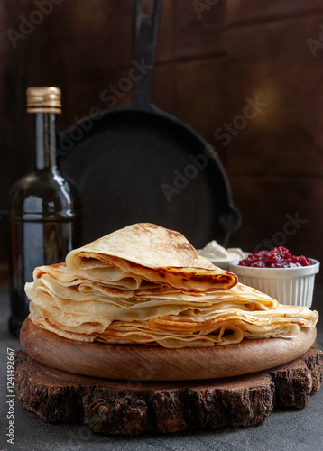 Delicious homemade pancakes with sour cream and jam photo