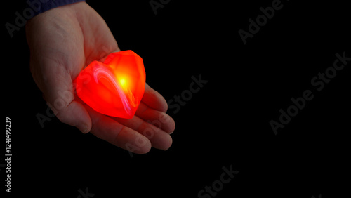 Obraz na płótnie Hands gently holding a glowing heart symbol w salonie