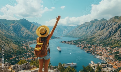 Breathtaking view of a woman waving from a mountain overlooking Kotor Bay in ...