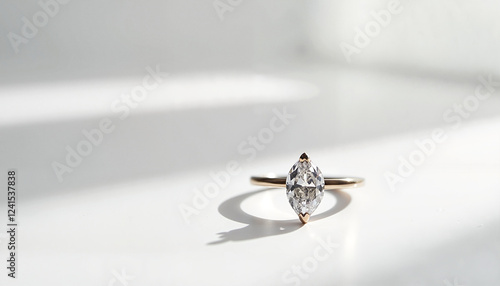 Marquise-cut diamond ring on white surface in natural light