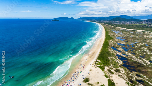 Preserved Brazilian beach with sandbanks and splendid nature on a sunny day with green sea photo