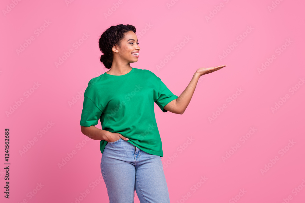 Photo portrait of pretty young girl look hold empty space wear trendy green outfit isolated on pink color background Photo portrait of pretty young girl look hold empty space wear trendy green outfit isolated on pink color background