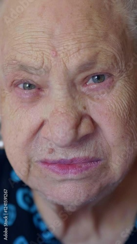 Vertical: An extreme close-up of a 90-year-old woman’s face, revealing the depth of age and experience. photo