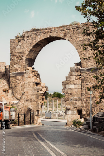 Stone arched gate in Greek style in Side. Vespasian's Gate in the old tourist town. Landmark