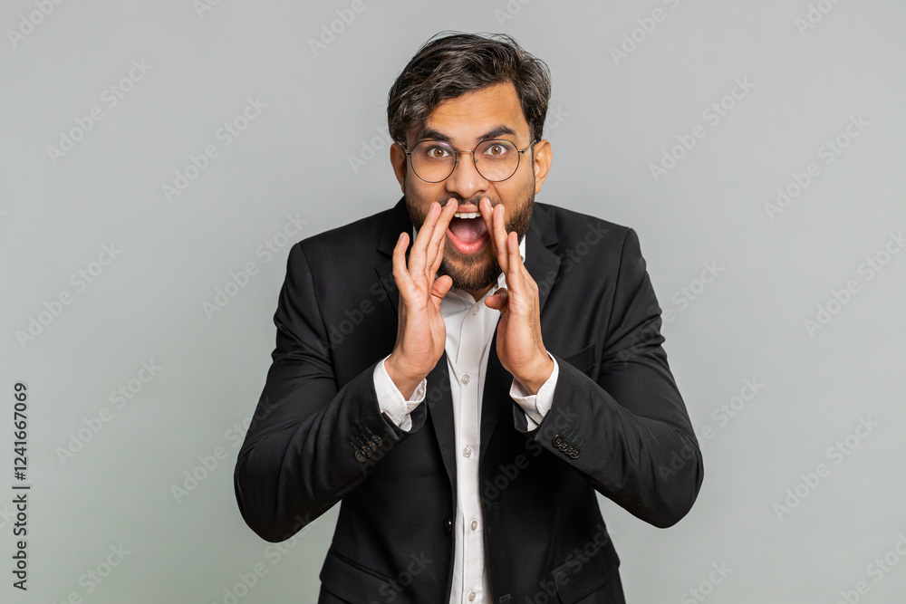 Keep my secrets, silence. Indian businessman whisper news rumors holding hands near mouth share gossip quiet. Arabian guy telling interesting confidential story isolated on gray background. Lifestyles Keep my secrets, silence. Indian businessman whisper news rumors holding hands near mouth share gossip quiet. Arabian guy telling interesting confidential story isolated on gray background. Lifestyles
