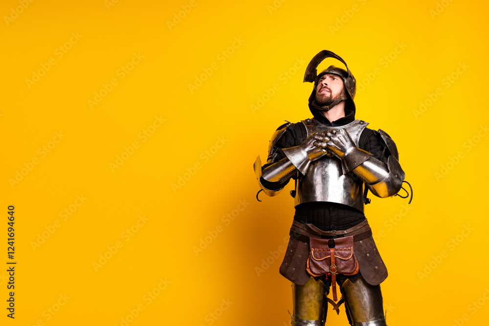Knight in shining armor posing with expressive gesture on bright yellow background Knight in shining armor posing with expressive gesture on bright yellow background