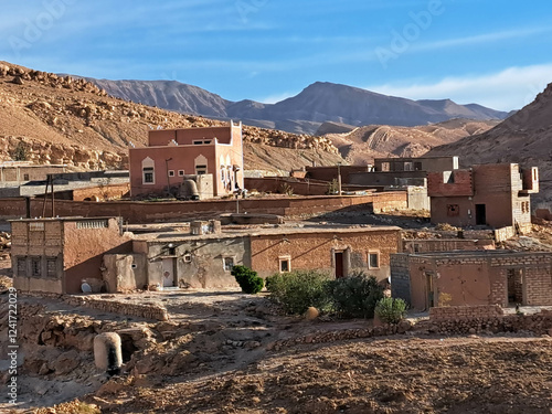 Ancient Village Nestled in Arid Landscape Under Clear Blue Sky in the Mountains of North Africa During Daylight Hours