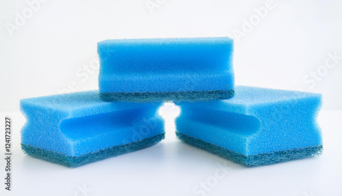 Blue kitchen sponges for dishwashing on white background. Foam scrubber. Dish cleaning sponge.