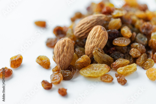 Appetizing almonds and sweet raisins on a light background. Vegetarian food, healthy sweets