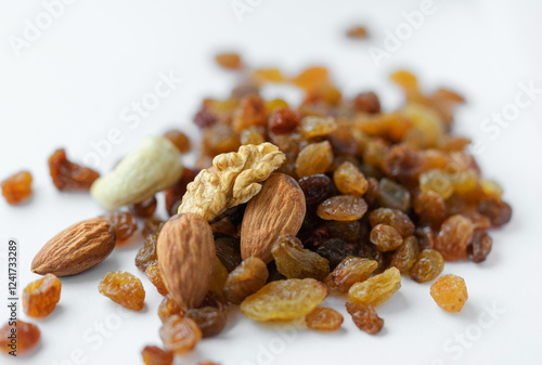 Vegetarian food, cashews, walnuts, almonds and appetizing raisins on a light background. Vegetarian food, natural sweets