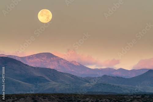 USA, New Mexico, Bosque Del Apache National Wildlife Refuge. Sunrise and full moon setting. photo