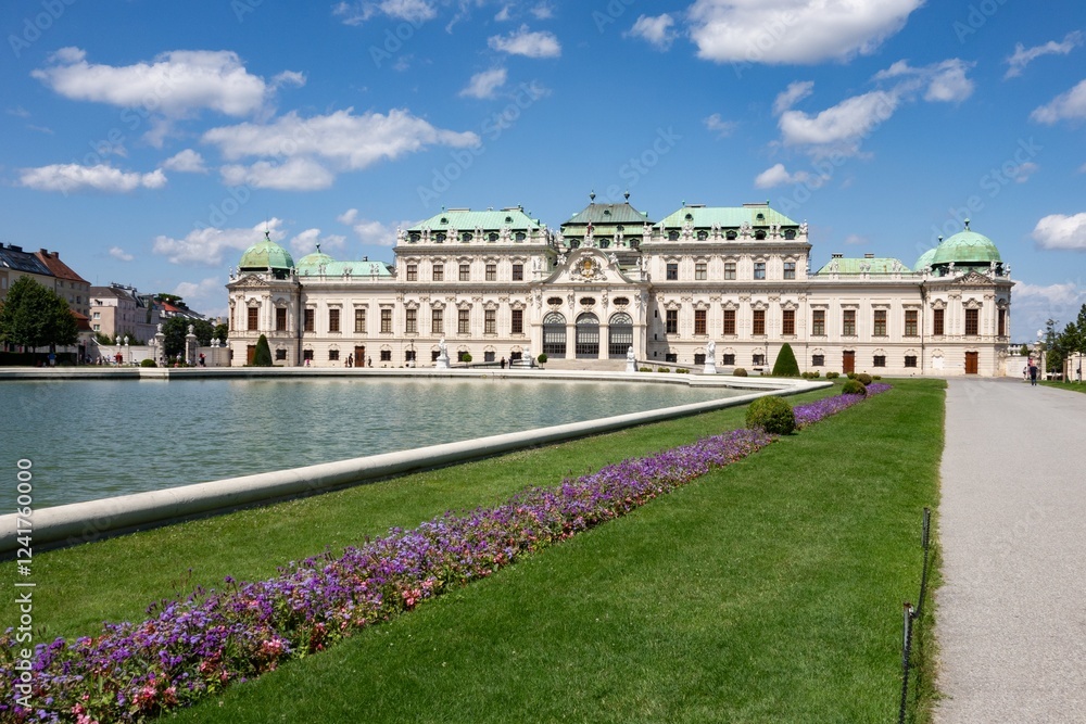 Belvedere chateaux in Vienna, Austria with Grosse Basin pool, purple flowers, unrecognizable tourists