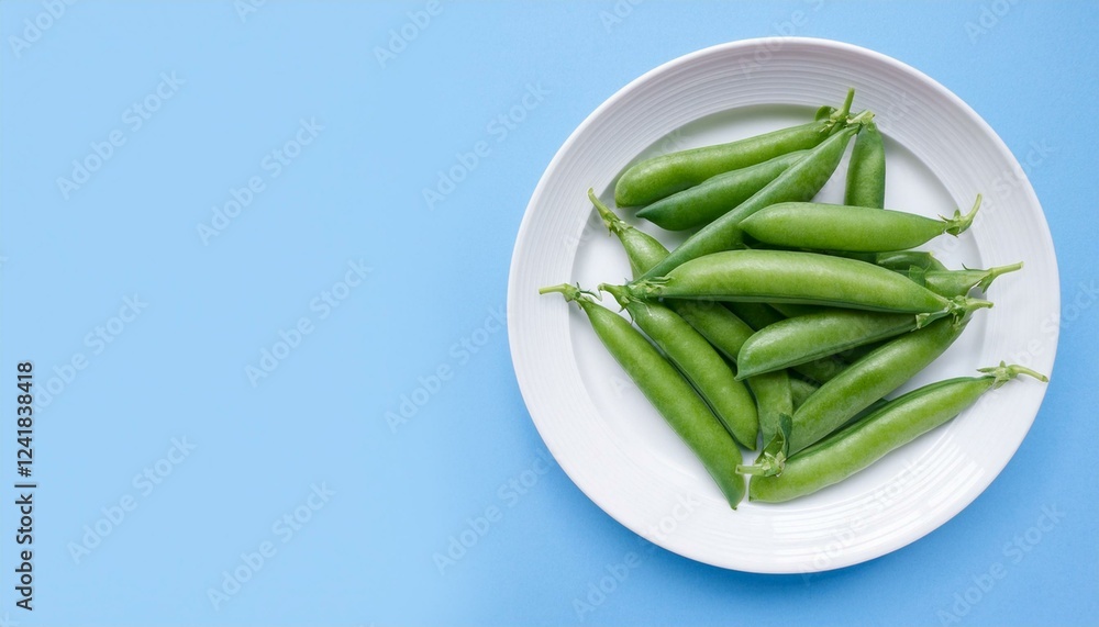 Fresh green peas on a white plate against a light blue background. Fresh green peas on a white plate against a light blue background.