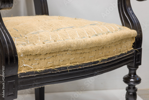 Frame of an old or antique chair or sofa, with upholstery missing.