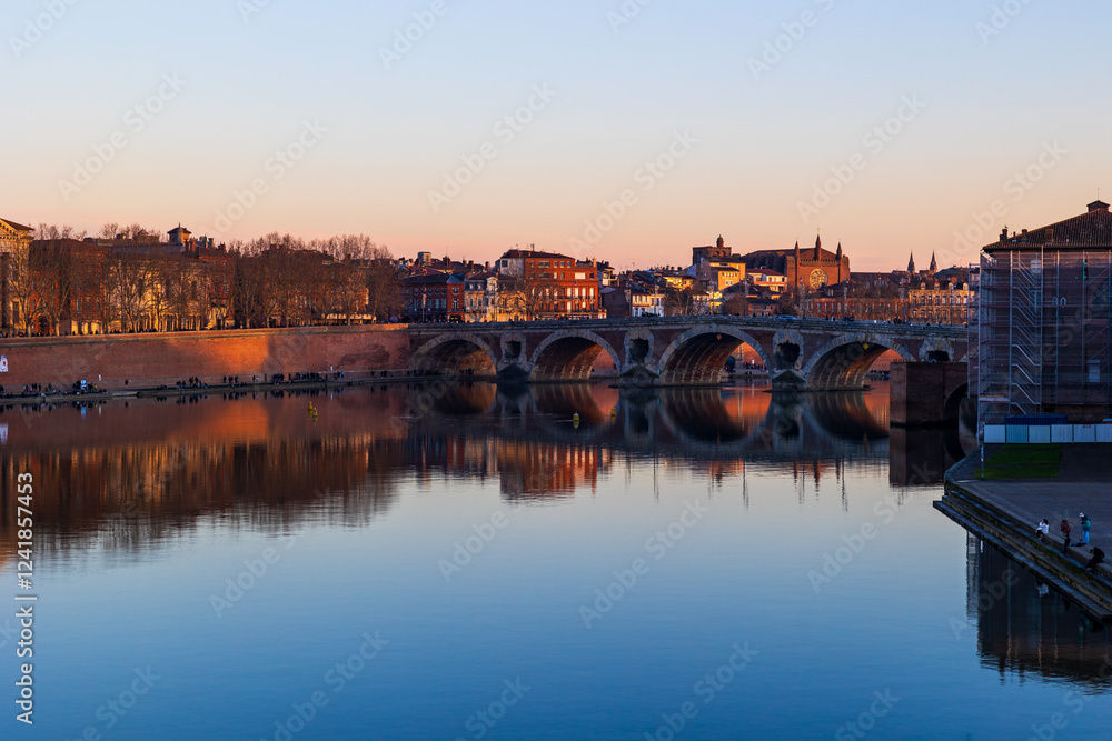 Fototapeta premium Pont Vieux Crossing the Garonne in Toulouse and Notre-Dame de la Dalbade Church at Sunset, Seen from the Opposite Bank