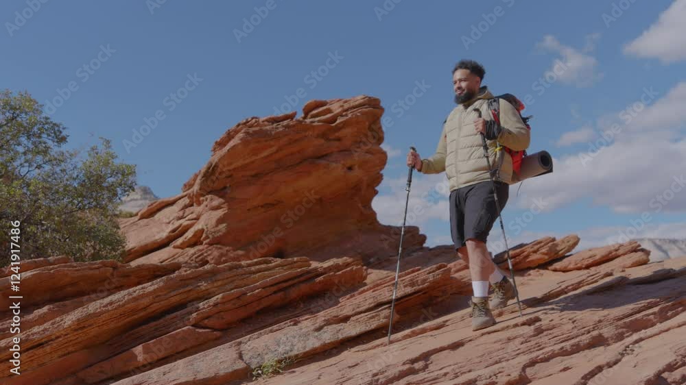 An African American male hiker stands proudly atop the stunning red rocks of Zion National Park, showcasing the breathtaking beauty of nature and the exhilarating thrill of travel and exploration An African American male hiker stands proudly atop the stunning red rocks of Zion National Park, showcasing the breathtaking beauty of nature and the exhilarating thrill of travel and exploration
