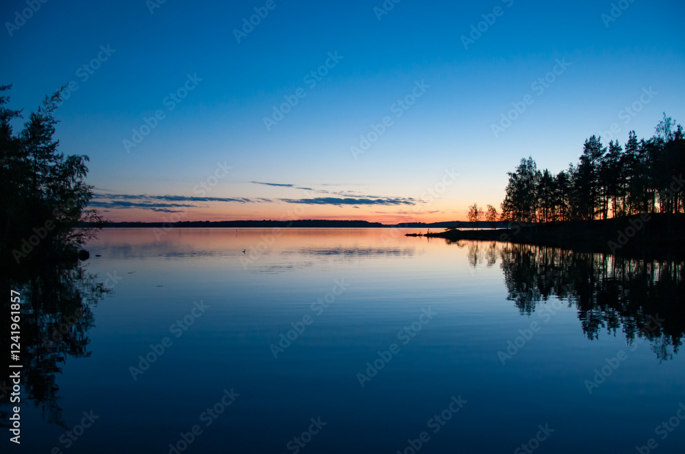 Fototapeta premium Early summer night by a calm lake in Finland
