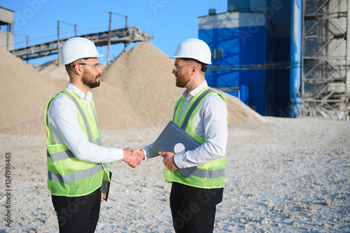 Two engineers at a stone crushing plant. The concept of quarrying.