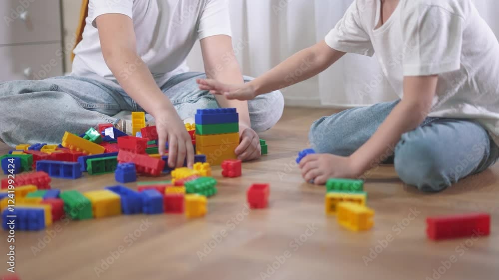 Lifestyle two children playing with blocks. A group of children are assembling a construction. A group of kids play with toys. Two kids stacking blocks. Lifestyle two children playing with blocks. A group of children are assembling a construction. A group of kids play with toys. Two kids stacking blocks.