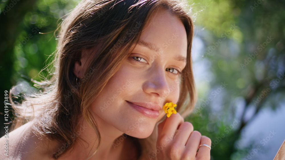 Gentle woman posing camera at summer portrait. Lady holding flower reading book Gentle woman posing camera at summer portrait. Lady holding flower reading book