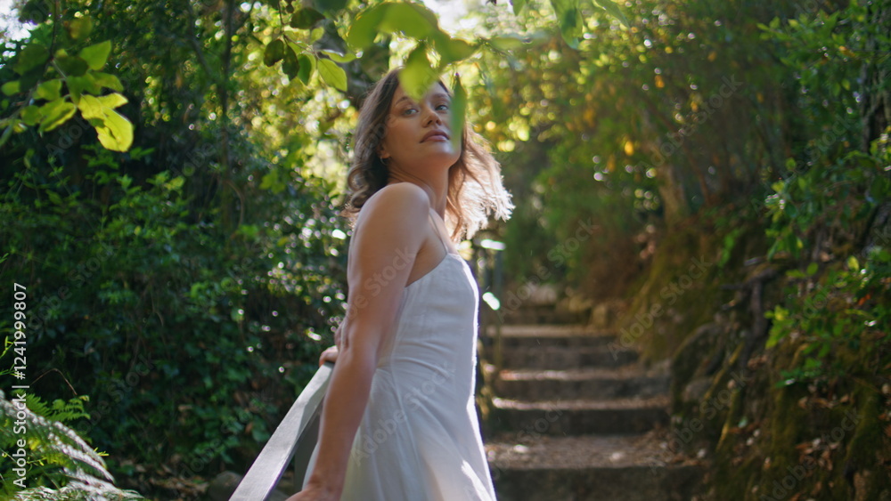 Naklejka premium Romantic girl strolling park stairs enjoying calm summer nature beauty closeup
