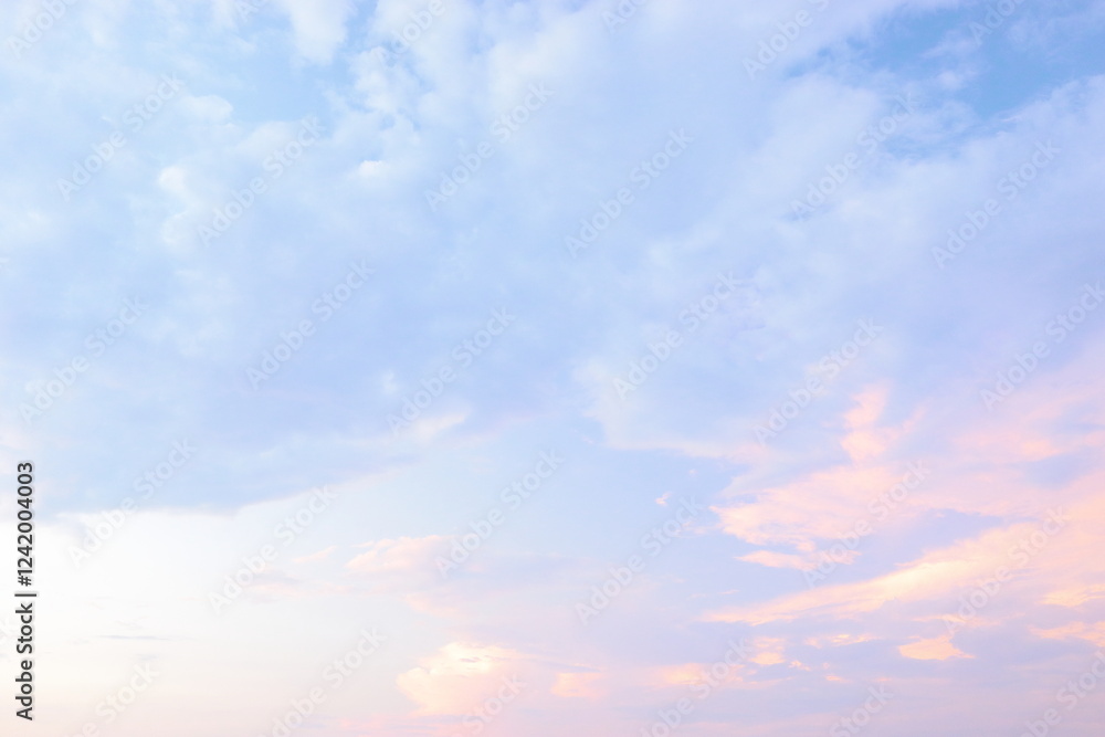 Soft pastel clouds fill the sky at sunset over a serene horizon during a tranquil evening in nature. Soft pastel clouds fill the sky at sunset over a serene horizon during a tranquil evening in nature.