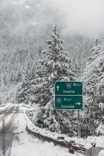 Snowy Mountain Road with Seattle and Spokane Highway Sign I90 - Winter Landscape in Washington State
