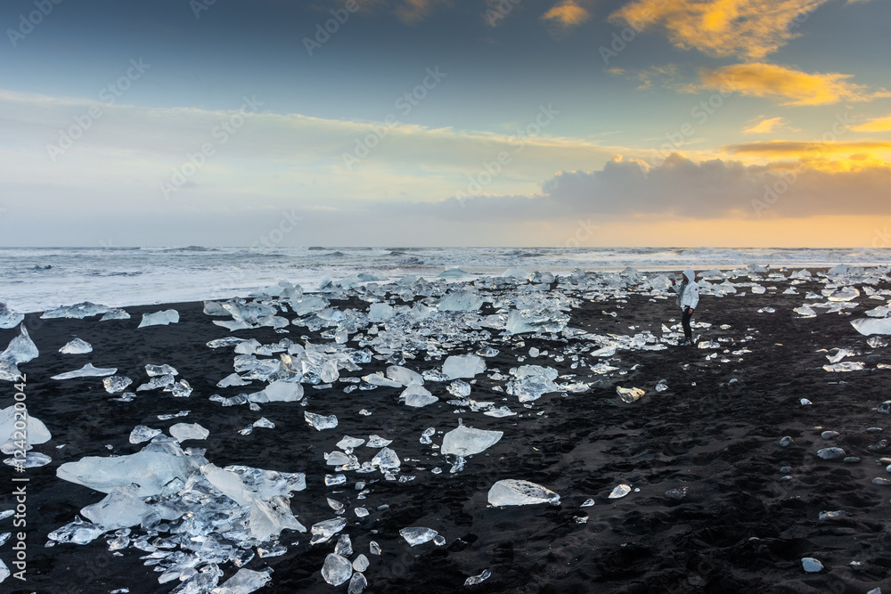 Amazing sunset over the Diamond Beach, volcanic black beach with icebergs from the Jokulsarlon glacier lagoon, Iceland
