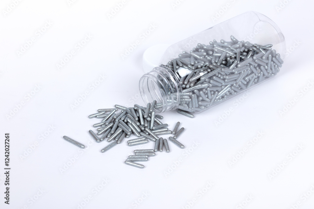 Fototapeta premium Spilled Silver Sugar Sprinkles from Plastic Bottle – Shiny Edible Cake Decorations for Desserts, Cupcakes, and Baking