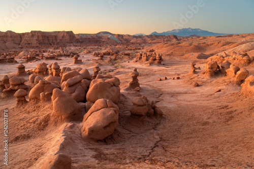 Whimsical hoodoos in Goblin Valley State Park, Utah. Henry Mountains are in t...