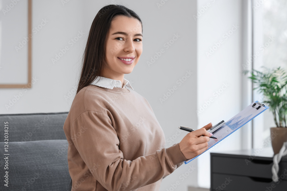 Young businesswoman writing report in office Young businesswoman writing report in office