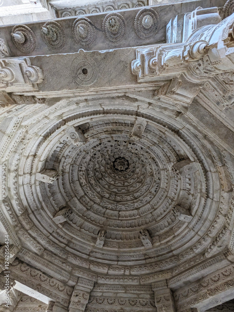 A dome with flowery patterns receding into the center on marble Udaipur, India
