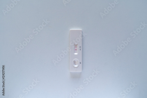 Positive Covid test on a white table