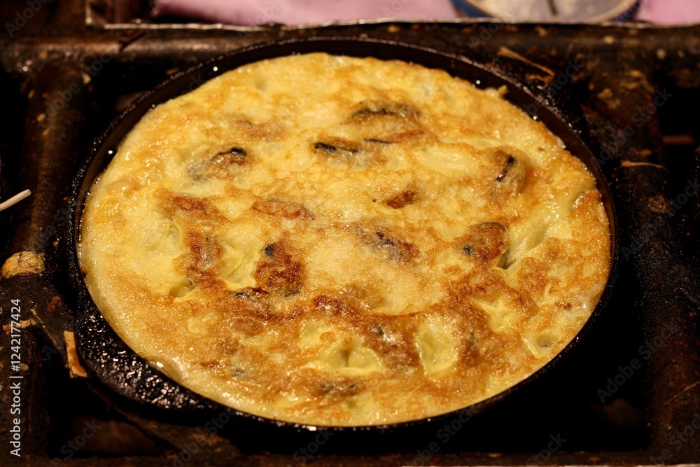 A freshly cooked omelette served in a skillet, showcasing a golden-brown texture and delicious ingredients. A freshly cooked omelette served in a skillet, showcasing a golden-brown texture and delicious ingredients.