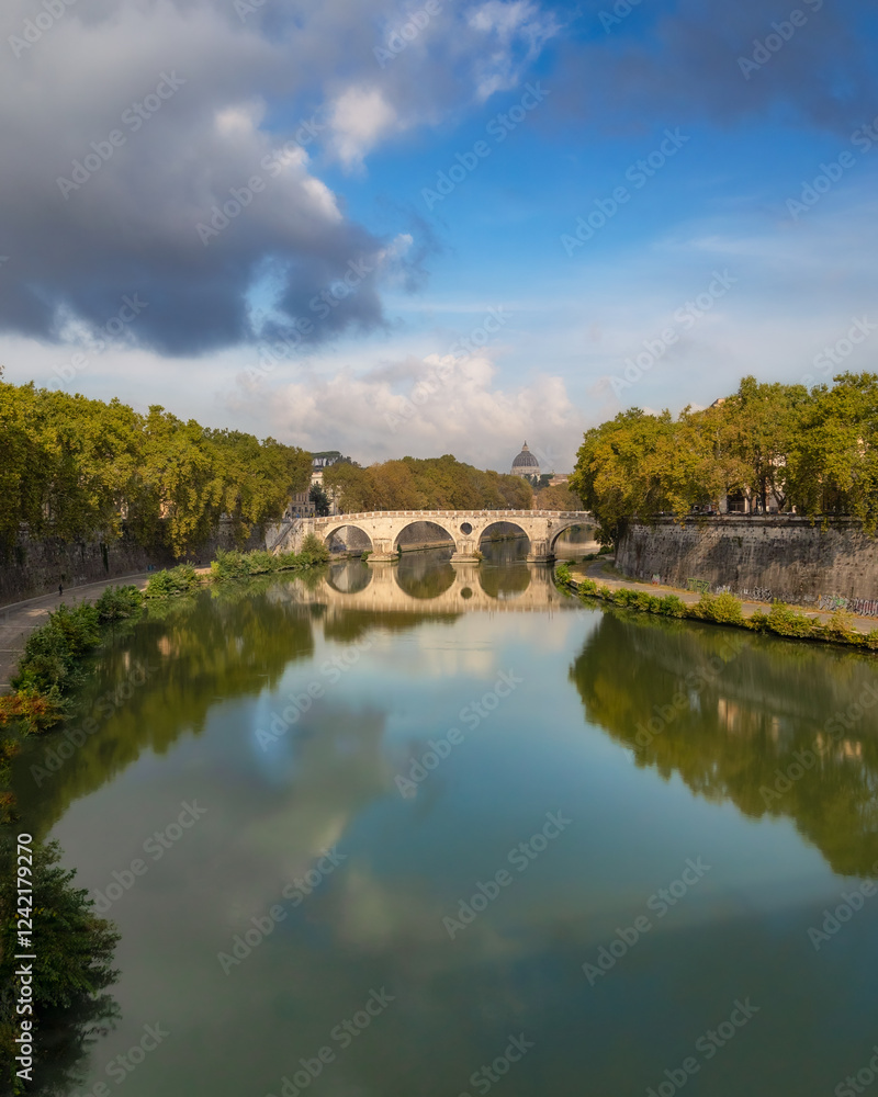 Reflection of a historic arched bridge crossing the Tiber River with Vatican City in the background. Ponte Umberto I Reflection of a historic arched bridge crossing the Tiber River with Vatican City in the background. Ponte Umberto I