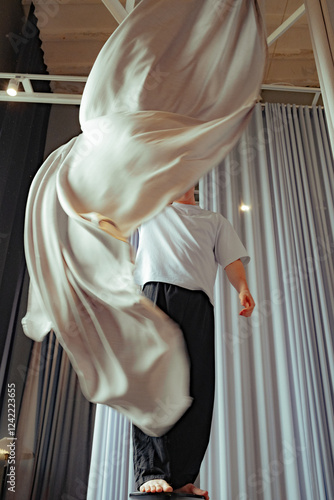 Performing art with fabric in a studio setting during daylight photo